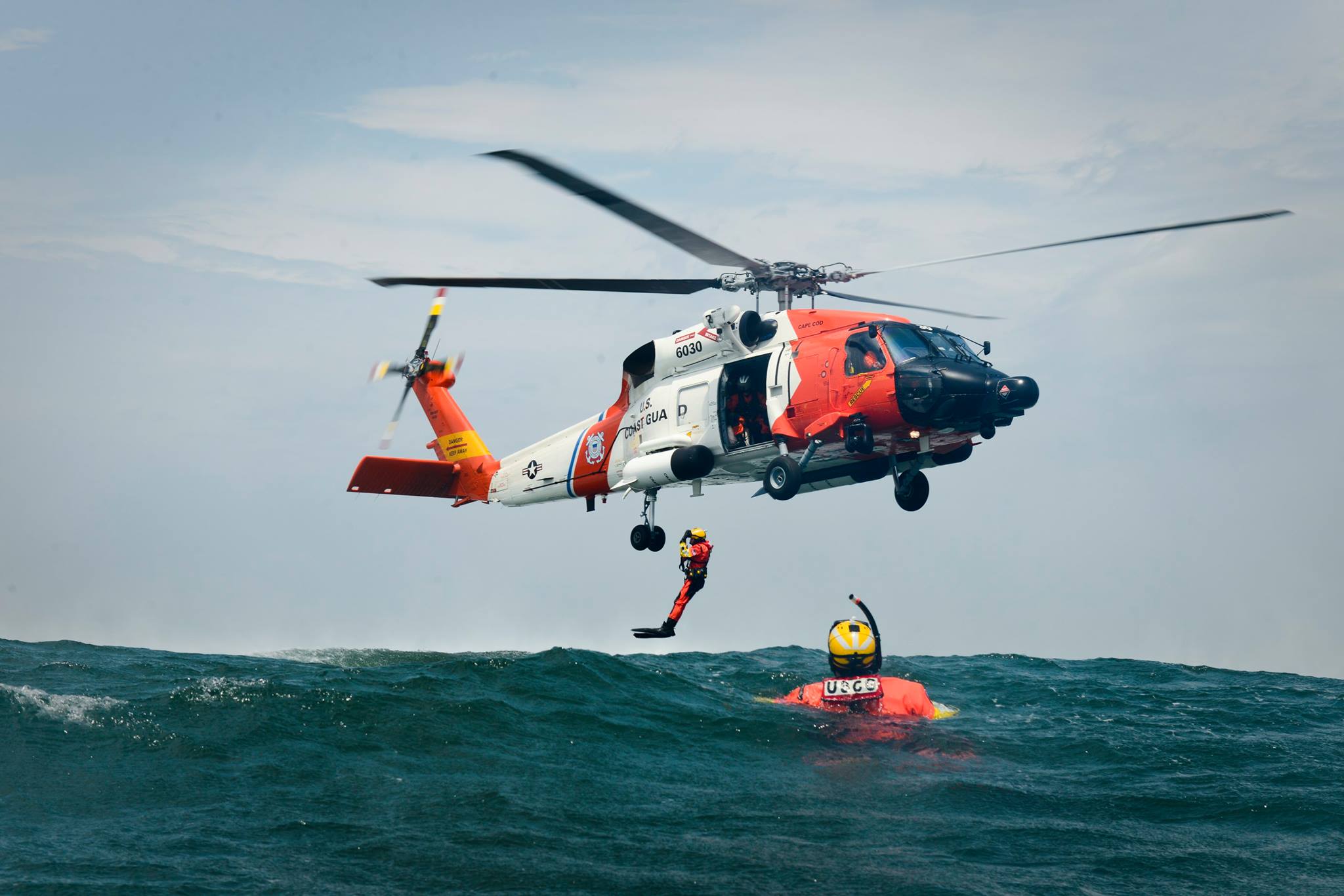a helicopter flying over a body of water