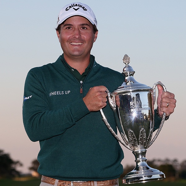 Kevin Kisner holding a wine glass posing for the camera